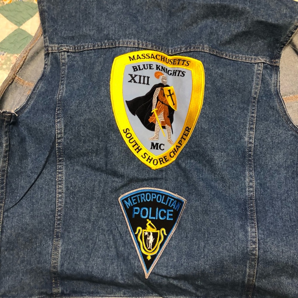 Motorcycle jacket with Massachusetts police patches on it.